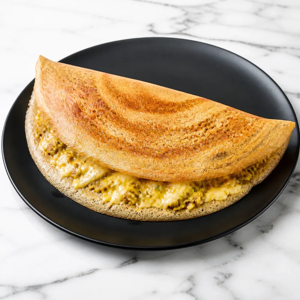 Dosa stuffed with mixed cheese and masala.