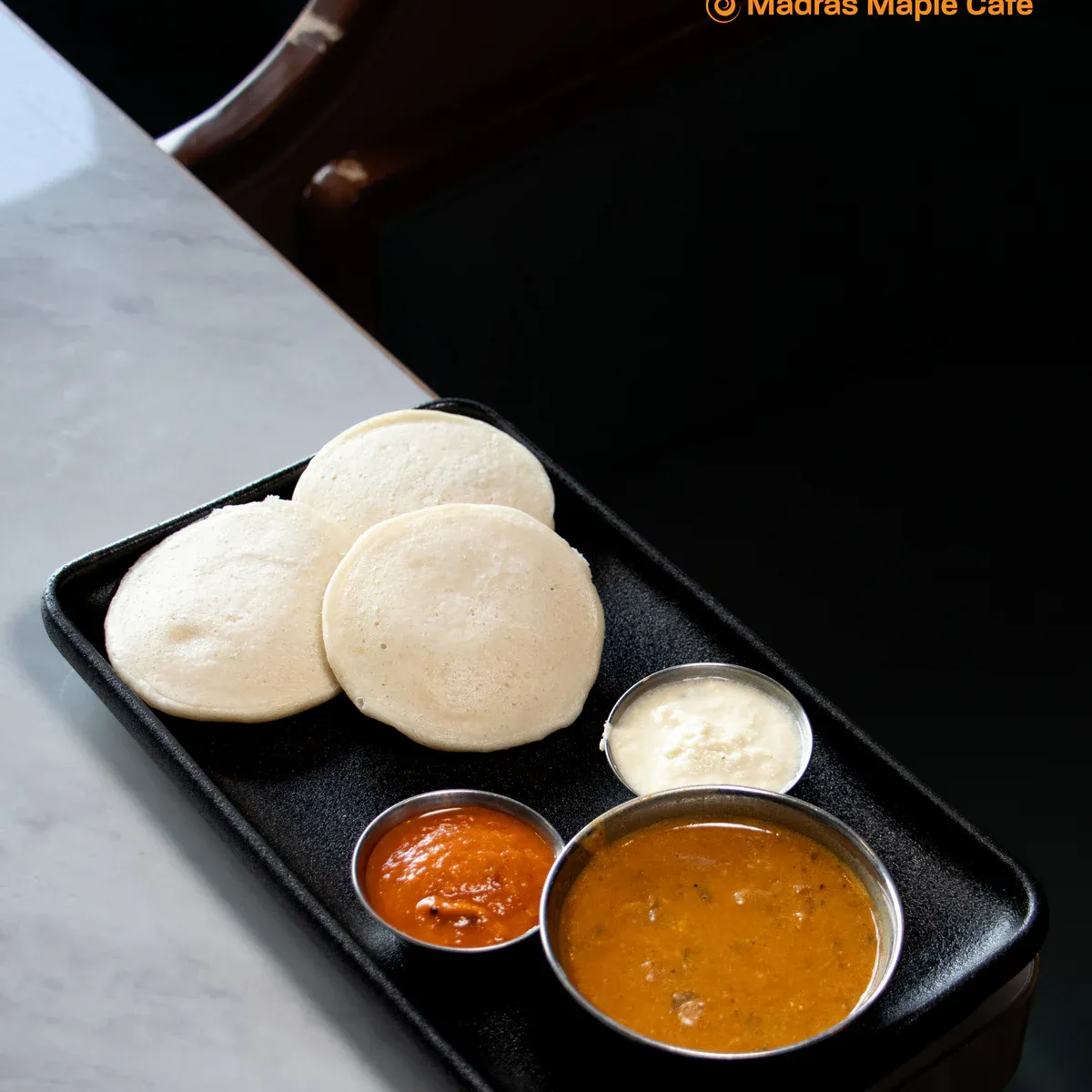 Three steamed rice and lentil cakes served with sambar and chutney.